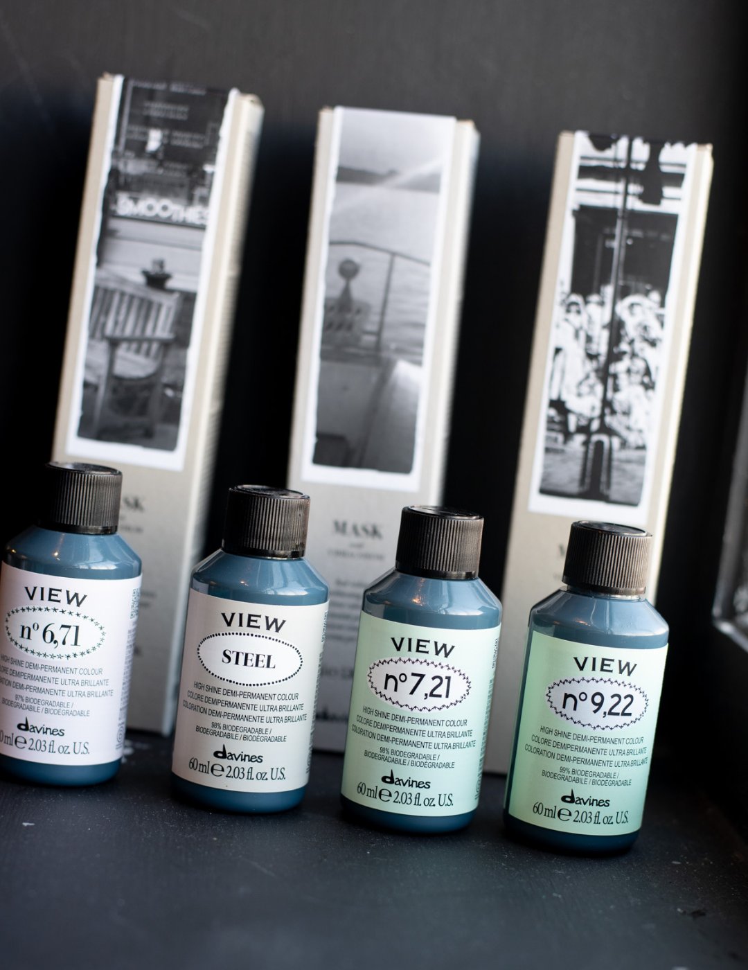 A row of Davines View demi-permanent hair color bottles and boxes displayed on a shelf.