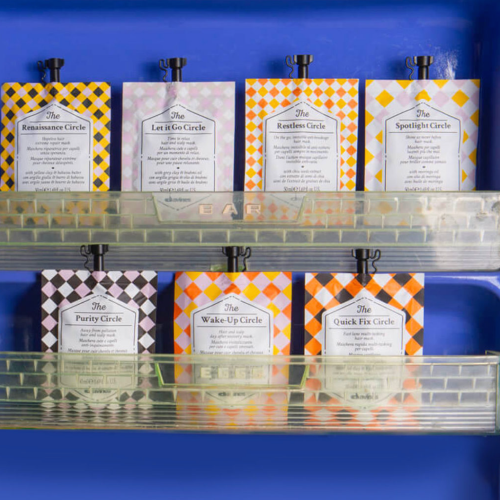 Davines The Circle Chronicles hair mask sachets, such as Purity Circle and Quick Fix Circle, displayed in a blue organizer in New Orleans, Louisiana.